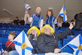 Family members of Nova Scotia skip Jill Brothers – Sou'Westers and all – were cheering her team on during the Scotties Tournament of Hearts at Centre 200 in Sydney Tuesday including, in front from the left, her son Casey, 4, husband Paul Brothers, step father Gifford Fralac, and in back from the left, mother-in-law Susan Brothers and friend Elspeth Carmody, mother of Nova Scotia curler Erin Carmody. Jill has a huge family following at all tournaments and bonspiels.