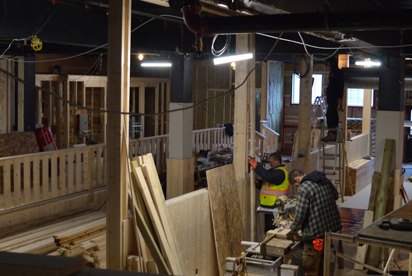 Workers at the site of the new Cape Breton Farmers’ Market continue to build vendor stalls Tuesday on the lower level of what was the Smooth Hermans cabaret until February 2010. The opening date has been delayed again to sometime early in the new year.