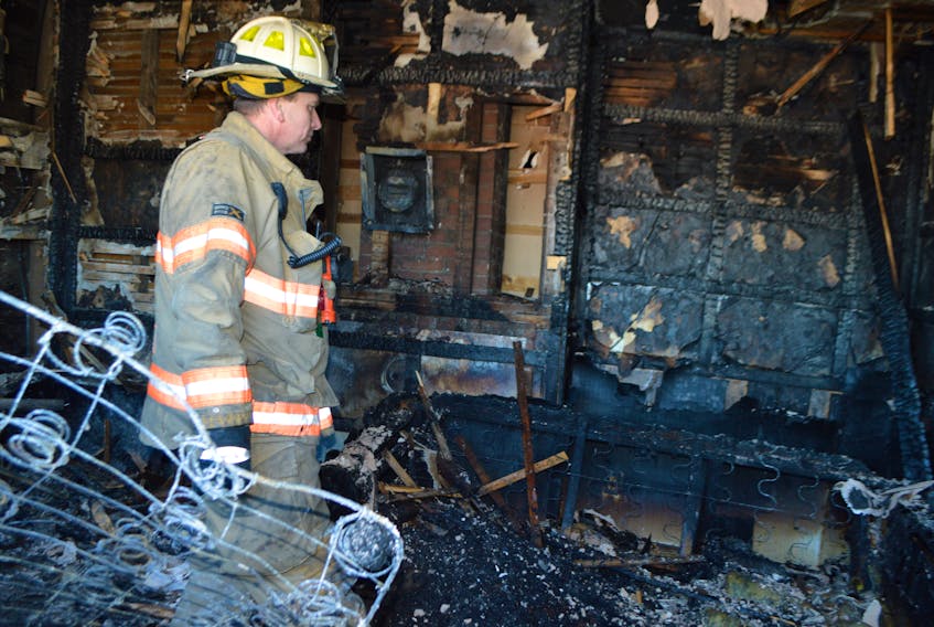Glace Bay Fire Chief John Chant looks around at the debris in the living room of half a company house at 56 Seventh St., Glace Bay, Thursday afternoon, after a fire destroyed the duplex and claimed the life of one of the family’s dogs. Glace Bay firefighters were able to revive two cats. There was minor smoke damage to the adjoining side.