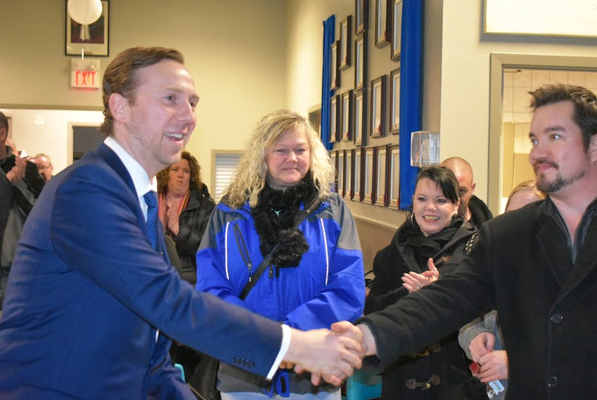 Iowa businessman Anthony Marlowe was greeted with applause Thursday evening when he met former ServiCom call centre employees at the Ashby branch of the Royal Canadian Legion. About 300 people were on hand to meet the new owner of the call centre and shakes hands with Chris Feltrin of Sydney, who has worked with ServiCom off and on since 2003.