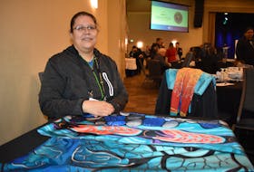 Loretta Gould, a painter who has used her art as inspiration for her clothing line, displays some of the clothing available on her website. Gould was one of four women who participated in a panel discussion on exporting to markets outside Nova Scotia at the Think Export NOW Conference at the Membertou Trade and Convention Centre on Tuesday.
