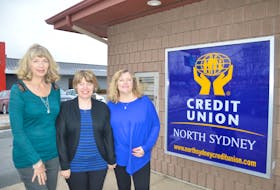 From left, Khristine Stubbert, Bonnie MacKenzie and Patricia Leyte stand near the entrance of the North Sydney Credit Union on King Street, Tuesday. The North Sydney location will celebrate its 80th anniversary at its annual general meeting next week.