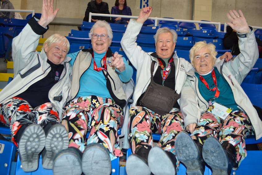 Good friends, from left, Bev Kinshella, of Saskatoon, Sask., Grace Potter, of Brandon, Man., Grace’s sister, Mary Carruthers, of Beaumont, Alta., and Shirley Kot of Edmonton, Alta., have a little fun while decked out in the same attire at the Scotties Tournament of Hearts at Centre 200 in Sydney on Wednesday. Although the women don’t have any relatives involved in high-level curling, they’ve been traveling the country together to follow the sport for more than 20 years.