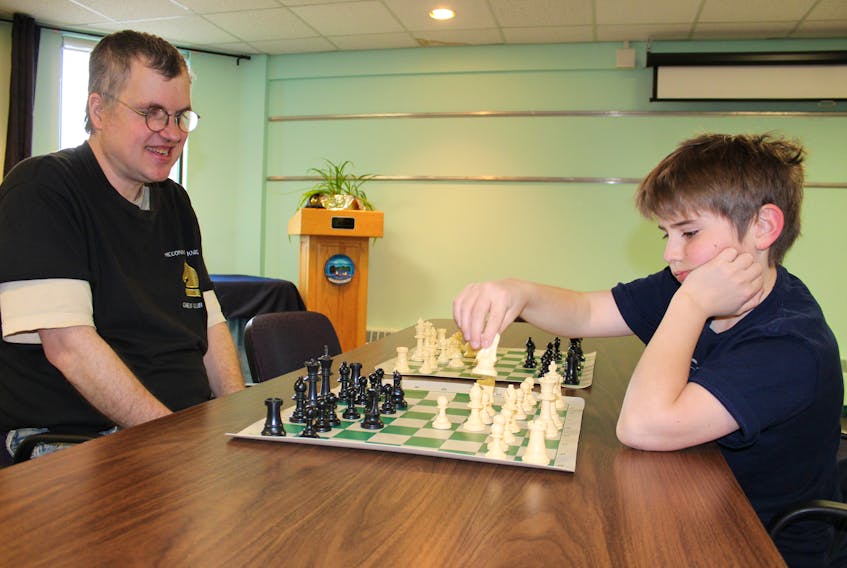 Bernie Buschell, left, is shown with participant Darius Fell of Sydney in the midst of a match known as Battlefield Chess, which they invented.
