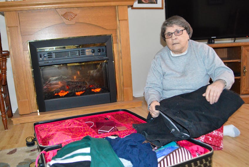 Tuesday afternoon, Paula Hines was found in her Howie Centre home on her laptop, her electric fireplace blazing — and her suitcase still packed. She said her sister and family are flying out Wednesday and she’ll be on the same flight as them.