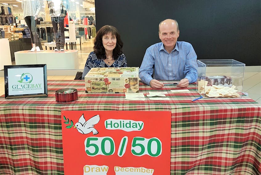 James Kerr and Elaine McQuarrie are shown selling 50/50 tickets at the Mayflower Mall community booth on Monday for the planned renal dialysis unit in Glace Bay. The public can visit them at the booth from opening until close on Saturday, Dec. 14, or Wednesday, Dec. 19, as well.