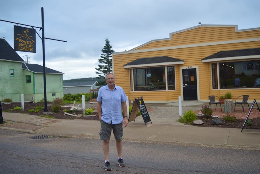 Parker Bagnell stands outside the Foggy Hermit café, which he opened on July 13 in Louisbourg.