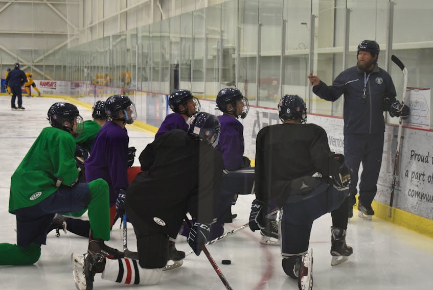 Sydney Academy Wildcats coach Sheldon Surette talks with his players during team practice at the Membertou Sport and Wellness Centre on Monday. The Wildcats will return to the Cape Breton High School Hockey League after not icing a team last season.