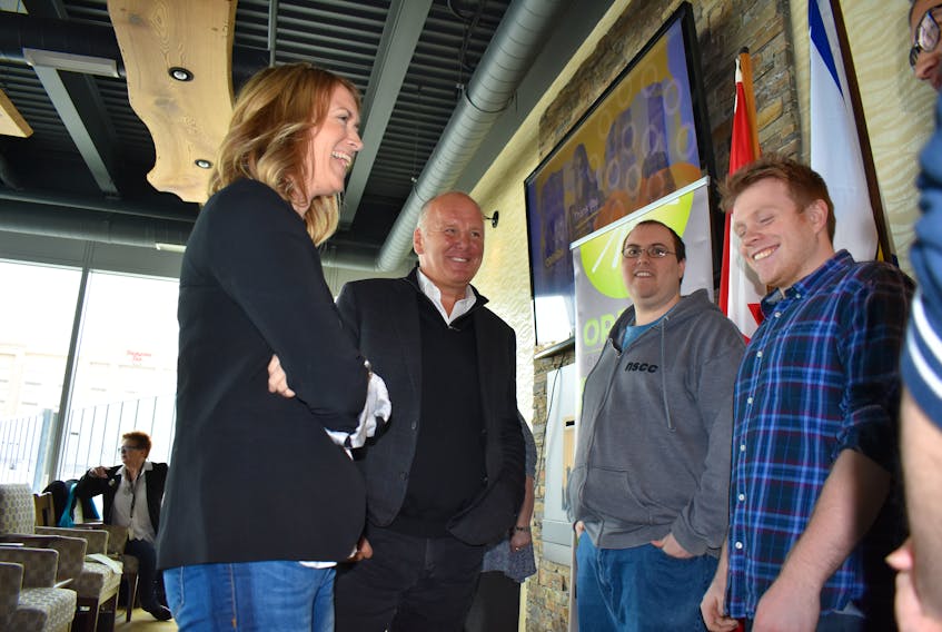 Orenda Software Solutions Inc. received a $200,000 repayable loan from the Atlantic Canada Opportunities Agency on Tuesday to develop its artificial intelligence software. From the left, Tanya Seajay, founder and CEO of Orenda Software Solutions Inc., talks with Mark Eyking, MP for Sydney-Victoria, and Orenda employees Cory Musgrave and Colton Campbell.