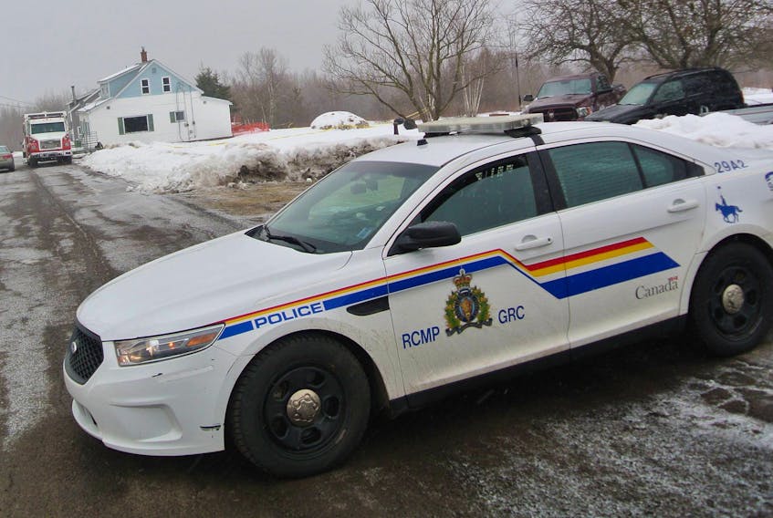 A lone RCMP cruiser blocks Beatons Lane outside Springhill on Thursday, where police continue to investigate a house fire and the death of two people found in the home.