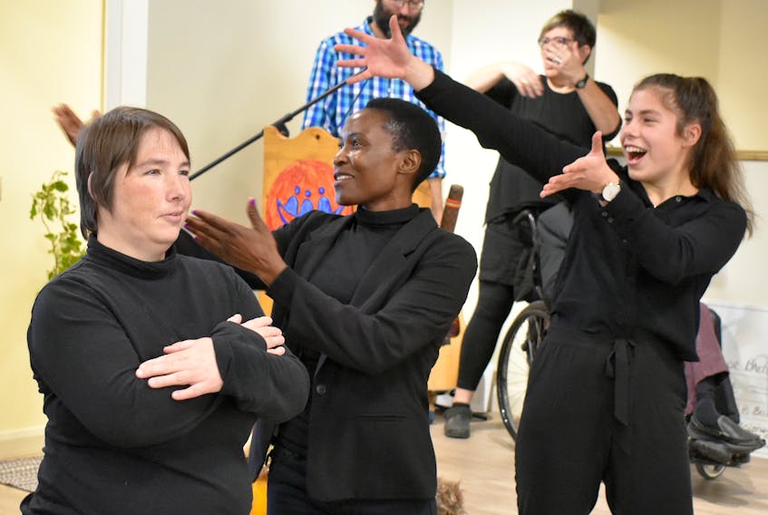 Lindsay Quimby, from left, performs alongside Lydia Biriwasha and Nina Yilmaz during the grand-opening of L’Arche Cape Breton's new $1.3-million, fully accessible facility, the Gathering Place.