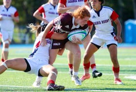 Elish Redshaw of the Saint Mary’s Huskies, right, breaks through a tackle during Atlantic University Sport rugby action against the Acadia University Axewomen earlier this season. The Point Edward native recently wrapped up her second campaign with the Huskies.
