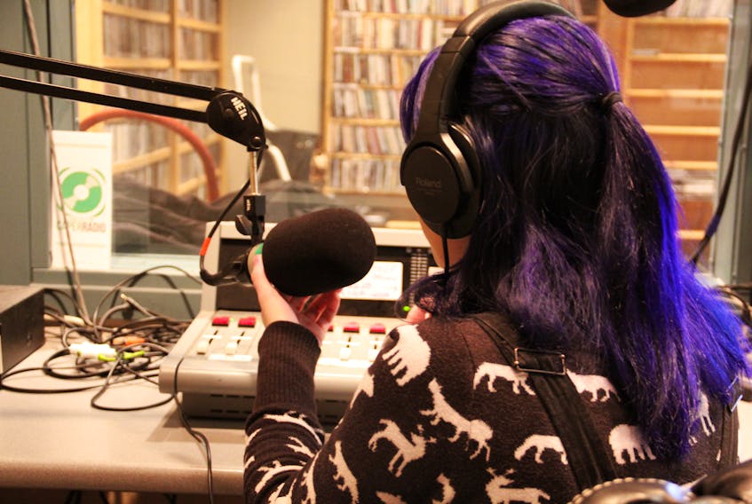 Jules Cameron is shown doing the daily programming for Caper Radio.