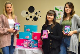 From left, Cape Breton Centre for Sexual Health executive director Vanessa Walker with Nova Scotia Community College social services students Victoria Postlethwaite and Cassidy MacLean at the centre in Sydney on Thursday. They are holding menstrual cups, behind them are boxes of the cups from the company Diva Cups. The cups were gifted to the centre by a Halifax-based non-profit group called Lively Friends which collects donations to buy the cups for organizations to give them to women and teenaged girls who can’t afford feminine hygiene products.