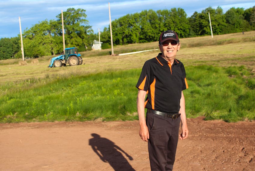 Alderdale Greens owner Eric Lewis stands next to the future site of a roughly 300-yard driving range at the nine-hole golf course in Point Edward.