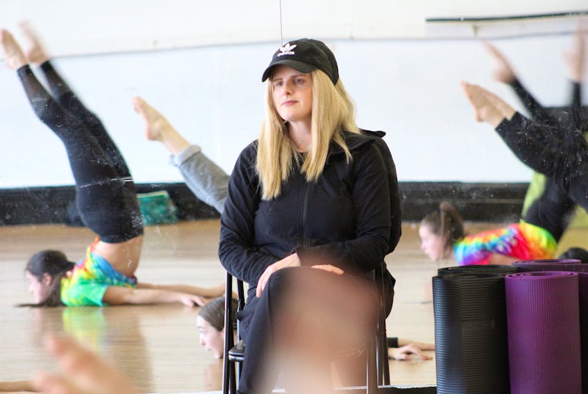 Lucy Wintermans watches intently as a group of her dancers practice before their upcoming competition. During her treatment for stage three breast cancer, Wintermans said she found going to work helped her stay positive and upbeat while managing some side effects.