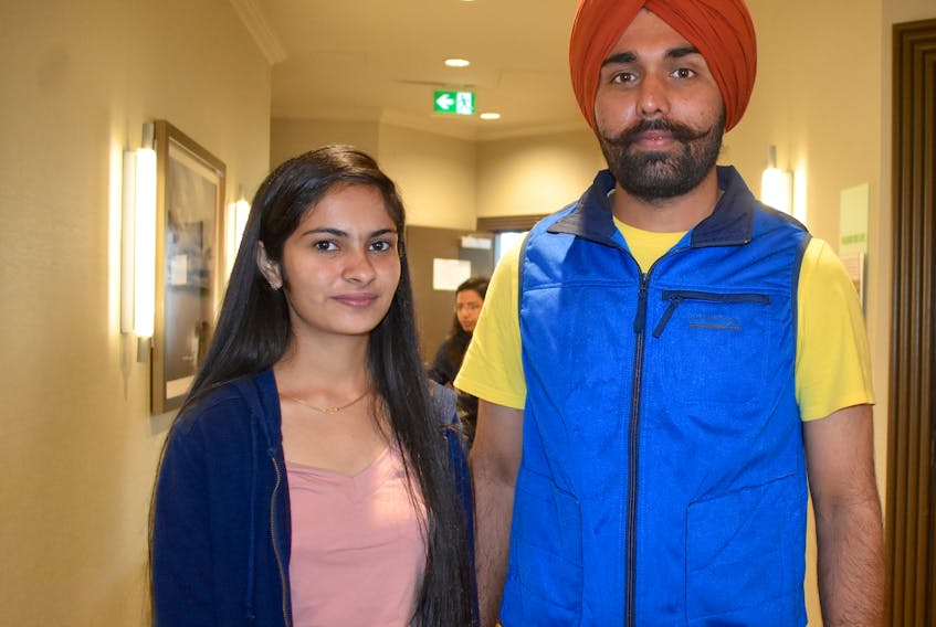 Jagmeet Sidhu, 24, left, and her husband Randhir Mann, 26, stand outside a job fair for a new Cape Breton call centre on Monday at the Holiday Inn in Sydney. The Cape Breton University student from Punjab, India, was one of more than 100 people who came to apply for a job at the centre, which will handle customer communications for FlannelJax's axe-throwing franchises in the U.S.