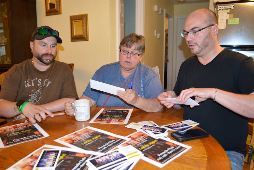 Some members of the New Waterford Giving Hands Society work on details for the Canadian Sexy Males On Tour event being held at the French Club in New Waterford on July 15 to raise money for charity. From left, Michael Al-Molky, Andrea Muise and Jason McDonald, all of Scotchtown, three former members of Royal Canadian Legion branch 15 in New Waterford, say they have reached out to numerous local charities they will be helping through various fundraisers they are preparing to kick off. The society says they will also be building a bank account and accepting applications from individuals and other non-profit organizations in the community needing help as well.