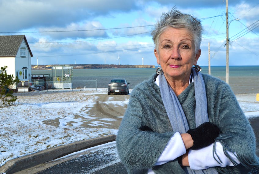 Karen Aucoin stands on Union Street in Dominion near her home by the ocean. Aucoin said she experienced electrical issues over a month and a half, losing some electronic items in the process. She said Nova Scotia Power denied her claim because she lives by the ocean and it’s not their fault salt corrodes their equipment.