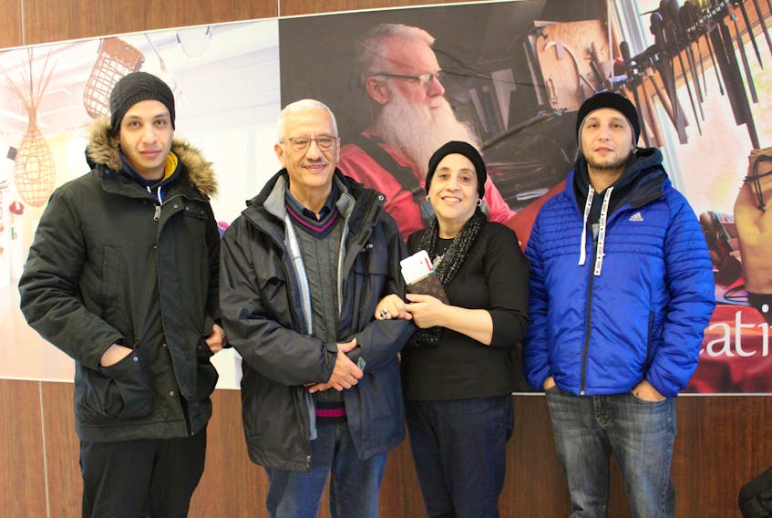 Mohamed Elgebeily and wife Laila El-Tarhouny were joined by their sons Sam, left, and Seif as the Egyptian couple waited to depart Sydney after spending their first Christmas in Cape Breton with family.