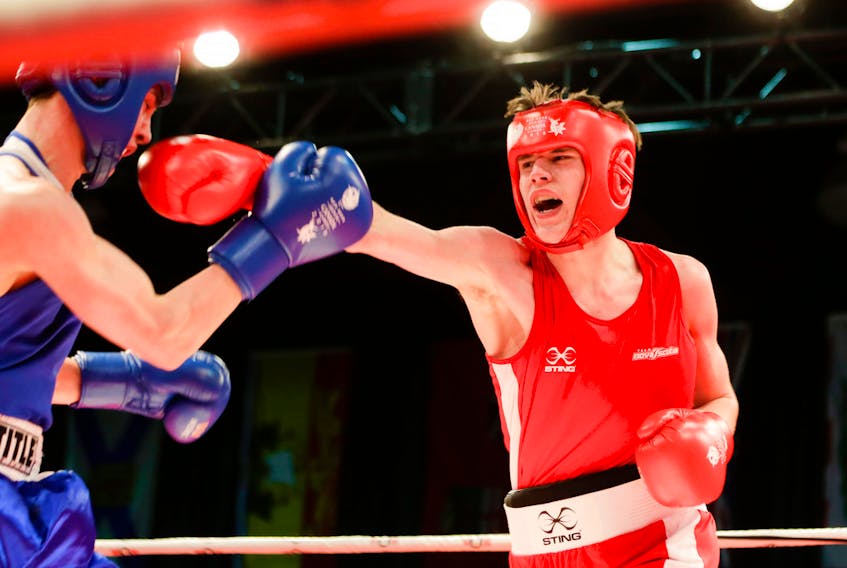 Matt Ross of New Waterford, right, lands a punch on Dylan Clark of British Columbia during the bronze medal bout in the 69 kg division at the Canada Winter Games in Red Deer, Alta., last week. Ross won the bout and is the lone Cape Breton athlete to medal at the event to date.