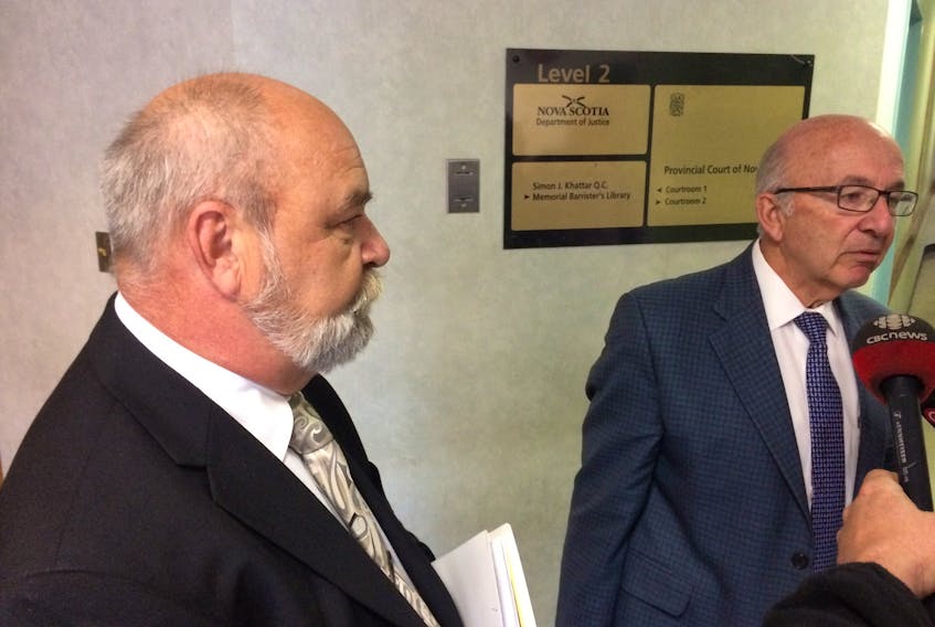 Crown prosecutor Steve Melnick, left, and Joel Pink, right, speak to reporters Wednesday after Pink’s client, Lawrence Summerell, was released on conditions. The high school teacher is facing five sex offences.
