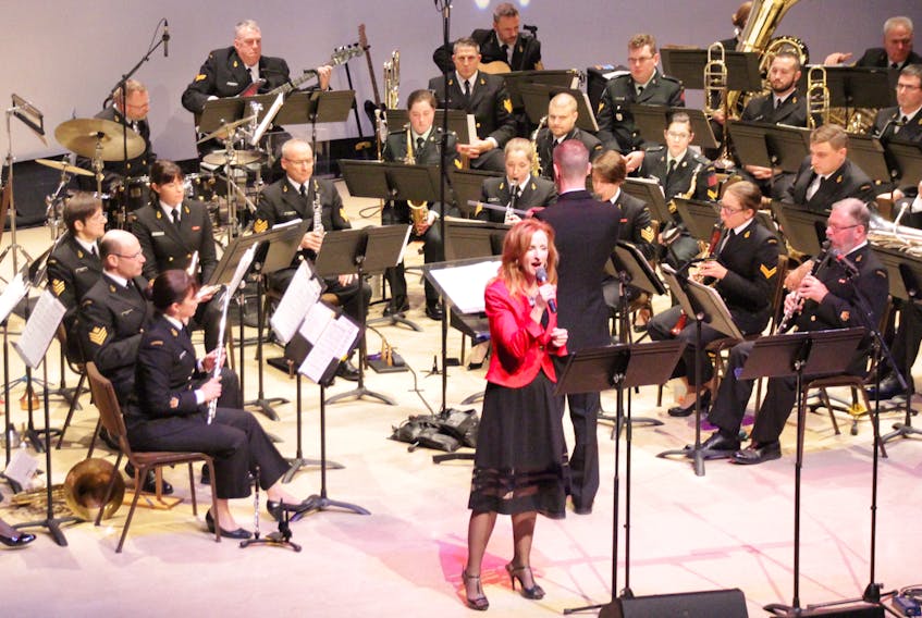 Emcee Liz Rigney is shown singing in front of the Stadacona Band during a 2017 version of Beary Merry Christmas, which returns to the Membertou Trade and Convention Centre on Dec. 4.