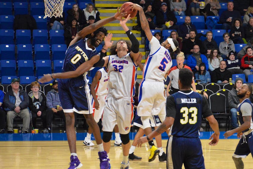 Cape Breton teammates Aly Ahmed, centre, and Antonio Biglow battle with Saint John forward Anthony Stover during the Highlanders 98-88 win over the Riptide at Centre 200 in Sydney on Tuesday evening. The Highlanders overcame a 20-point deficit to claim their second consecutive comeback victory.