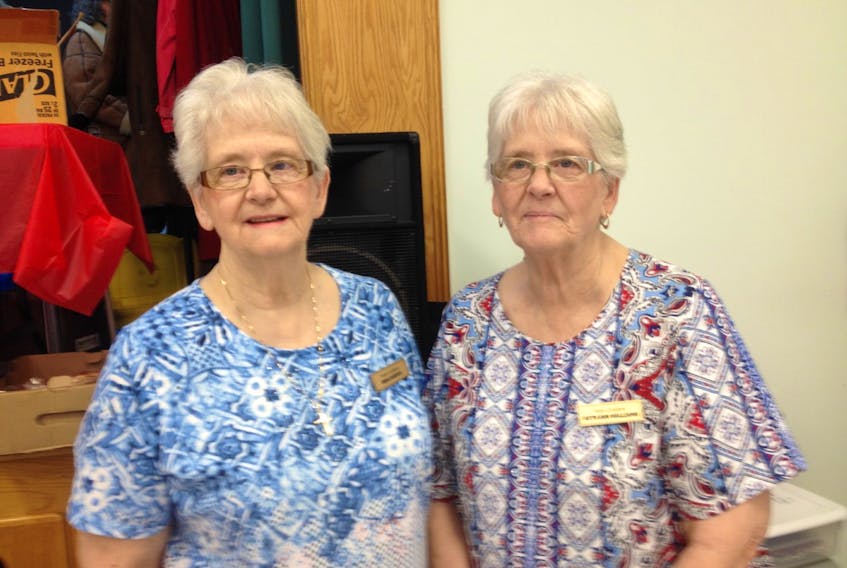 Identical twins Dora Murphy, left, and Ruth Anne Williams say they are at their best when they are doing something within the community.