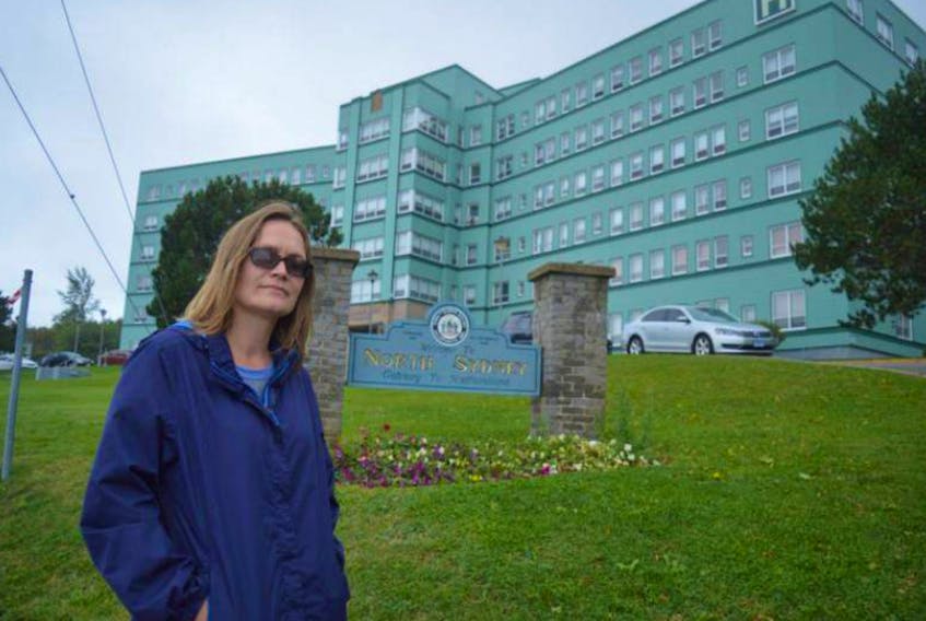 In this file photo, Lisa Bond stands in front of the Northside General Hospital in North Sydney. Bond has organized a community rally for Saturday to protest emergency room closures at the local hospital and encourages residents from across Cape Breton to join the event.