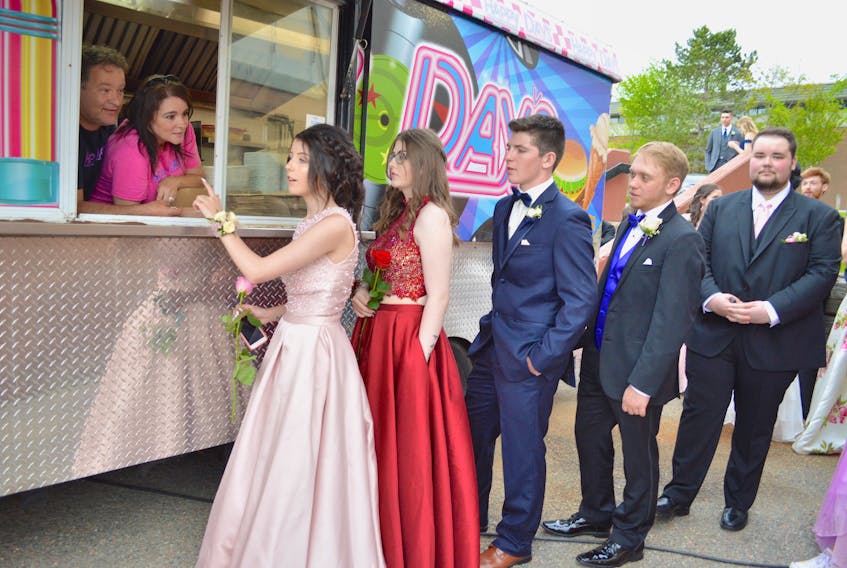 Dave LeBlanc, back left, owner of Happy Dayvs food truck, and his wife Debbie, chat with Breton Education Centre graduates and their guests in New Waterford, front to back, Madison Aucoin, Alyssa Burns, Brett Binder, Tony Tighe and Brandon Pearson. The food truck provided food for BEC’s safe grad party. BEC students will graduate today.