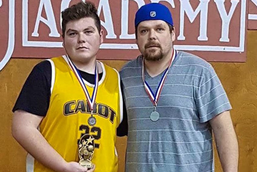 Daniel Briand, left, is joined by his father Ray while accepting an award for player of the game during his Grade 12 high school year.