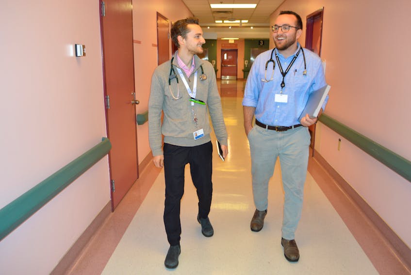 Third-year Dalhousie University medical students Ryan Densmore, left, of Fall River, Nova Scotia, and Connor Bray, of Sydney, both 25, chat while walking down a hallway at the Cape Breton Regional Hospital in Sydney, Friday. The two men are part of the Cape Breton Longitudinal Integrated Curriculum program being held for the first time here. The program allows Dalhousie medical students to get hands-on training in a rural community for a full year instead of completing short placements in various communities. The main focus of the program is to provide an excellent medical educational experience for the third-year medical students but locally it’s hoped the students will enjoy Cape Breton and upon finishing school and consider relocating here.