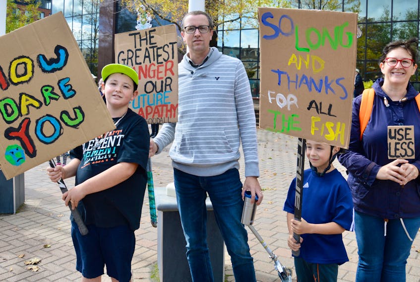 The Strike for the Earth rally in front of Sydney’s Civic Centre Friday attracted people of all ages including this Sydney family. Shown here, from left, are, Shepard Targett, Mike Targett, Felix Targett and Ardelle Reynolds.