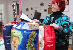 Wanda Earhart of Every Woman’s Centre looks over some of the packages that have already been dropped off in support of the centre’s annual Adopt a Family program. Each year the program helps more than 600 families have a merrier Christmas season. To adopt a family, contact the centre.