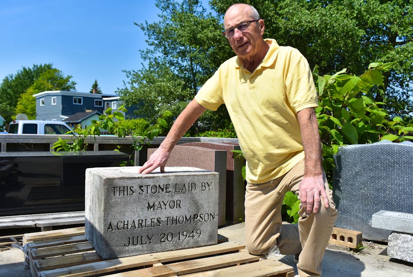 Chuck Thompson kneels down beside a stone in honour of his grandfather A. Charles Thompson, a former mayor of the Town of North Sydney. The stone was part of the former Thompson School in North Sydney and was laid during the construction process on July 20, 1949. It was removed prior to the demolition of the school earlier this month.