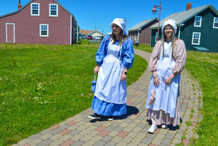 Interpreters Rebecca Harris, left, 22, a Cape Breton University student, and Jillian MacKeigan, 19, a Nova Scotia Community College student, stroll through the Miners’ Village at the Cape Breton Miners’ Museum in Glace Bay. The museum is looking for more volunteers and to that end there will be an orientation session at the museum on July 5 at 2 p.m.