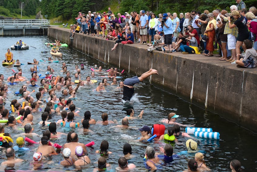 Hundreds of visitors, local and from away, gathered in St. Peter’s earlier this month for the Richmond County village’s annual Swim the Canal event. Above, a member of the Campbell clan, home for a family reunion, entertains participants and onlookers with his awkward entry into the historic waterway. Events such as this along with Cape Breton’s scenic beauty and renowned hospitality have kept island tourism number climbing.