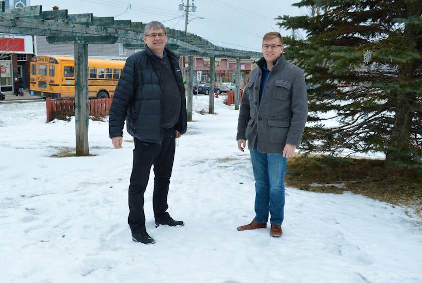 Dave MacKeigan, left, vice-president of bayitforward and Kyle MacDonald, a member, look over land by Town House on Commercial Street in Glace Bay, the general location where a new bandshell will be built, a project by the group. MacKeigan said this bandshell will be part of the effort to see the rejuvenation of the downtown area.