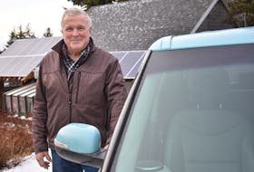 Bob Mesher and his 2016 Kia Soul EV parked at his home in Catalone. Mesher is one of only a few Cape Bretoners who own a battery electric vehicle.