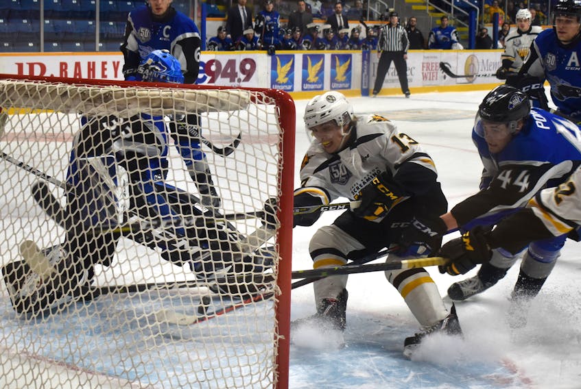 Félix Lafrance, middle of the Cape Breton Screaming Eagles jabs at the puck behind Saint John netminder Zachary Bouthillier, left, as Jérémie Poirier, right, tries to get a piece of the puck during Quebec Major Junior Hockey League action at Centre 200 on Thursday. Cape Breton won the game 10-3.