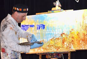 Artist Kenny Boone works on a canvas in front of those attending the fourth Growing A Creative Economy conference at the Membertou Trade and Convention Centre on Thursday.