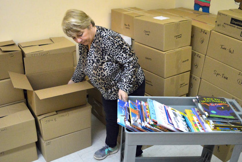 Cindy Tiller, branch manager of the Glace Bay Library, packs books in preparation for their big move into the new space on Commercial Street.