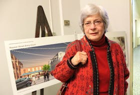 Margaret Young, who is both a former student and teacher at Holy Angels, stands in front of an architectural sketch of the building’s Nepean Street entry. Following the 2011 closure of the school, it was rebranded the New Dawn Centre for Social Innovation.