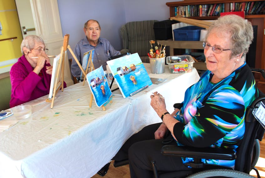 Dorothy Bungay, right, now paints with her left hand after suffering a stroke a decade ago. The North Sydney woman is among a group of seniors, along with Marguerite Goora, left, and Bill Kirby, whose work will be featured in a 12-month calendar as part of a fundraiser by the Northside Community Guest Home.