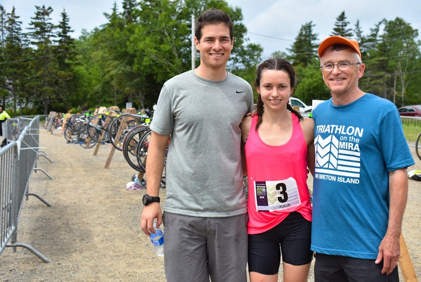 Winner of the women’s Olympic triathlon on Sunday in Albert Bridge, Julia MacDonald, poses for a picture with her fiancée, Ben Costello, left, and her father, Rick MacDonald. Julia convinced both men to compete with her and trained them both for their first triathlons.