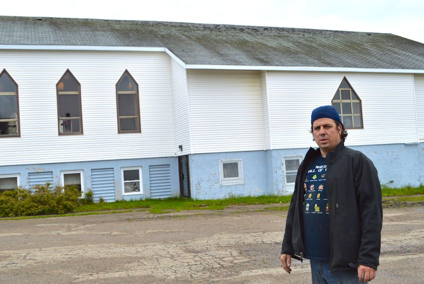 Peter Arapis, co-ordinator of the House of Healing Church of Cape Breton in Dominion, stands in front of the church which is in need of a new roof.