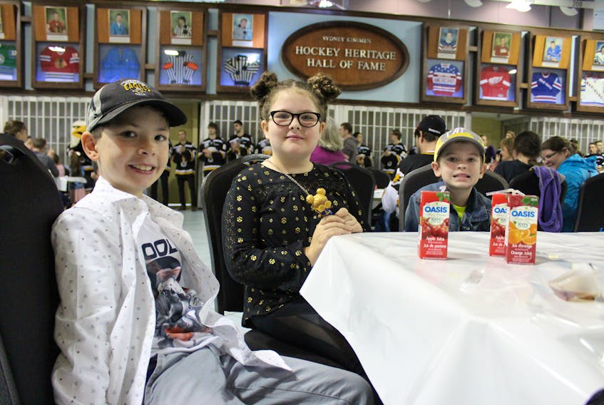 From left, Colton MacDonald, 8, his sister Maddison MacDonald, 9, and their cousin Cameron Larick, 5, were happy to have breakfast with the Screaming Eagles on Sunday at Centre 200.