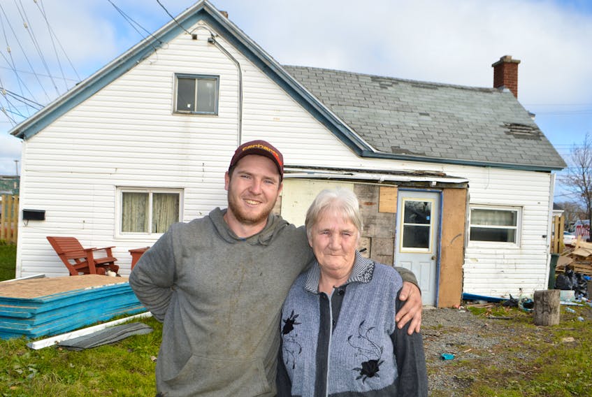 Jeremy Locke, owner of Locke’s Roofing and Construction in Bridgeport, stands with Jeanette MacDonald outside her home in Glace Bay. Locke, seeing her roof was in deplorable shape, simply knocked on her door offering to replace it for free back in the spring, but it took a little trick months later to get her to accept. MacDonald said she’s extremely grateful to Locke, as her roof has been bad for a couple years, but this past year took a beating with storms and there are numerous leaks in the house.