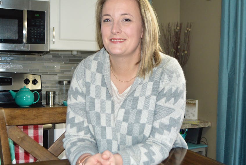Stephanie Pitchuck of Sydney relaxes in her kitchen. Pitchuck, born the first baby of the new year in Cape Breton in 1984, said celebrations may have been downplayed a bit because her mother was a single mother at the time.